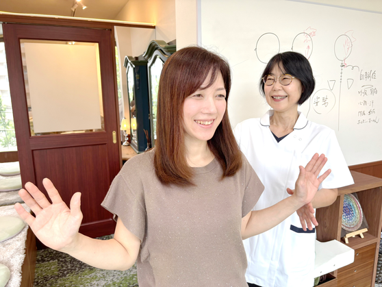 頭痛専門整体ともしびで施術後に頭痛予防の生活アドバイスを行っている様子。