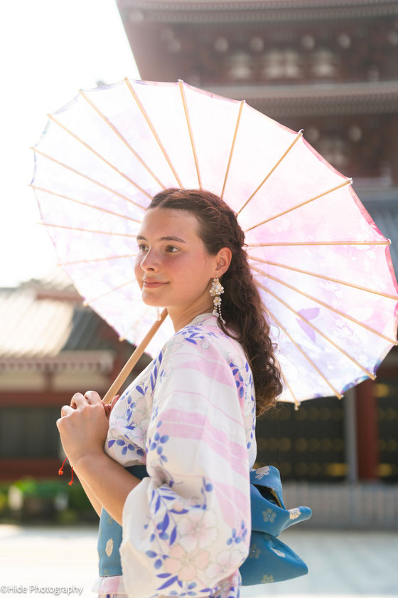 Woman in kimono holding a traditional Japanese umbrella during a Tokyo photoshoot