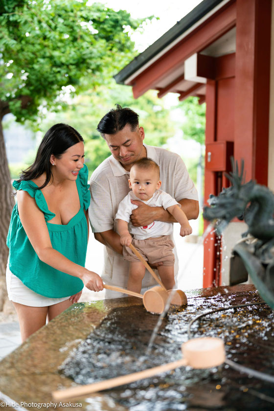 Family enjoying a traditional purification ritual at Sensoji Temple during a morning photoshoot in Asakusa Tokyo