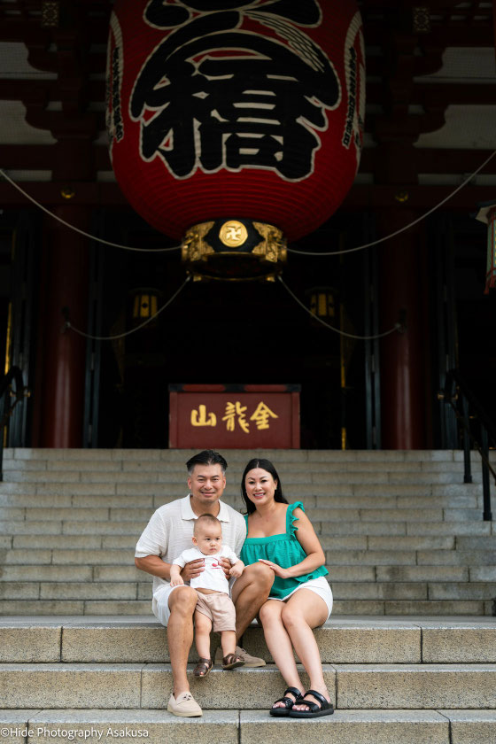 Family portrait beneath the iconic Kaminarimon lantern at Sensoji Temple in Asakusa Tokyo
