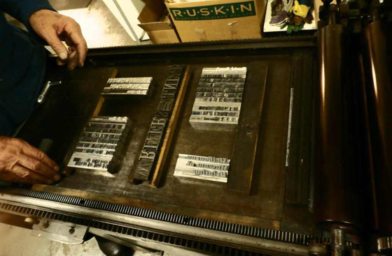 Michael making up the forme (the composed type and spacing, locked in and ready to ink up to print) on the bed of the press