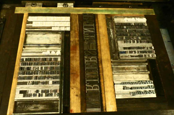 The completed forme. The type is now locked up and ready to print from. Note the wooden and metal blocks between the type (called furniture), used to create the space between sections of text.