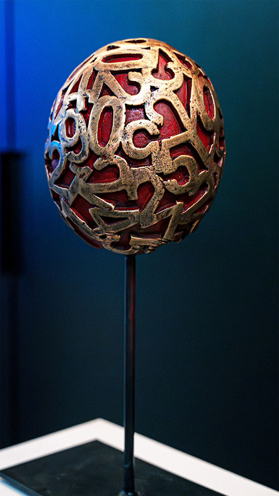 Contemporary bronze sculpture Eggs by Paolo Grassi with mixed patinas, red core and gold numbers – studio view