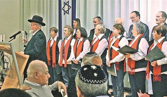 Während der Chor traditionelle jüdische Lieder sang, zündete Rabbiner Michael Bar-Lev die erste von den insgesamt acht Kerzen des Lichterfests Chanukka in der Synagoge an. Foto: Gredel