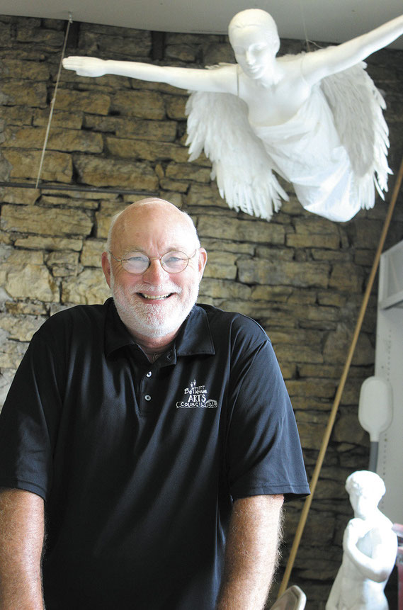 David Eischeid poses for a photo at his art studio above the Great River Gallery.