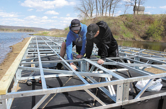 Justin Harms and Mike Valant worked to assembled the new 16 x 40-foot practice dock that arrived here from a company called Tiger Docks in St. Louis, Missouri last week. The dock, which was custom-designed to hold 30 skiers at once on the take-off side, w