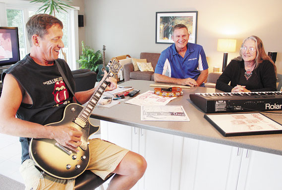 Jeff Theisen, Dave Valant and Jill Naegle, three of the original members of Slightest Idea, go over their songlist at the Theisen home south of town. The band will perform a set or two during Bellevue’s Reunion on the River Saturday at Cole Park.
