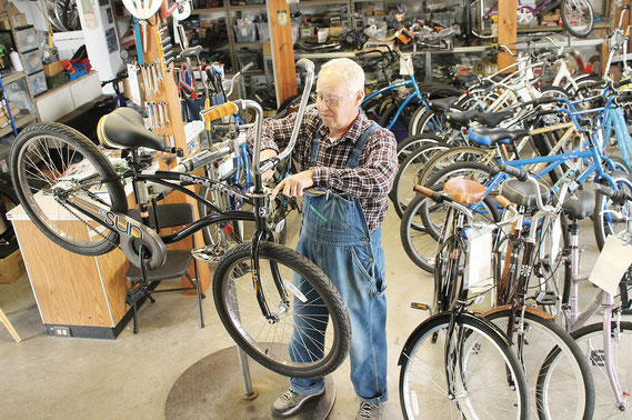 Mark Rogge, owner and lead mechanic at Bellevue’s Backwaters Bicycle Shop, works on one of his many Sun bicyles at his shop on South Second Street. The brand has been heralded for its unique and comforable “foot forward” design.