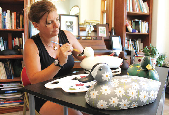 Shannon Witt works on one of her many duck decoy creations at her home south of Bellevue, 