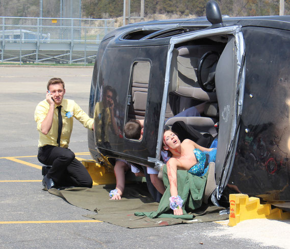 Marquette and Bellevue High Schools took part in the live portrayal of a fatal accident scene in which local emergency crews responded in real time. Above, Logan Schroeder finds Natalie Sullivan following the crash.