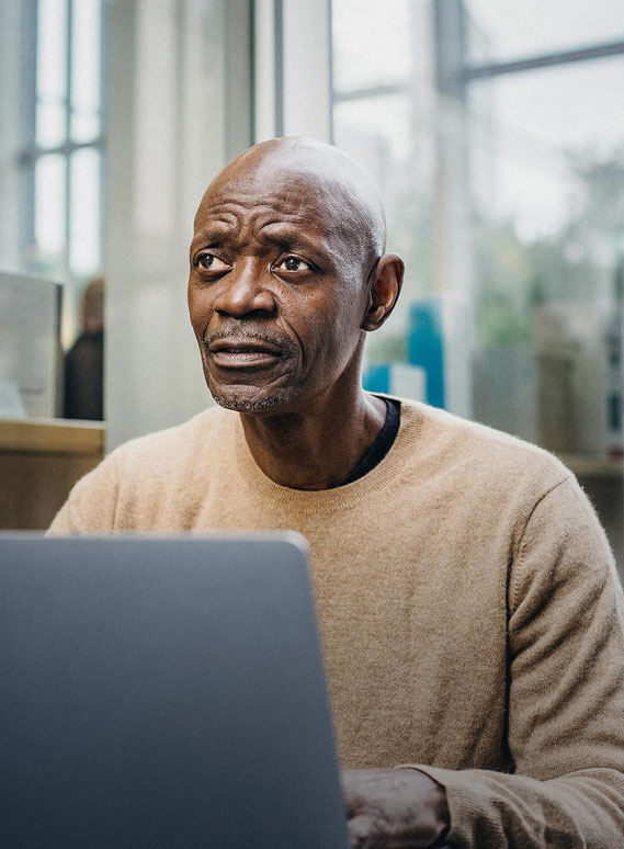 man in front of laptop in the claims process