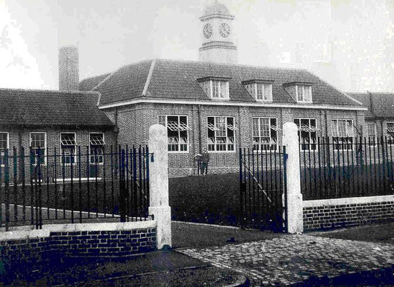 Mr. Fred Davies (Headteacher) stands outside the new school. I think this photograph might have been taken in 1930. There is no grass, mud tracks are on the drive, (builder's lorries?), the windows are open, (drying paint?).
