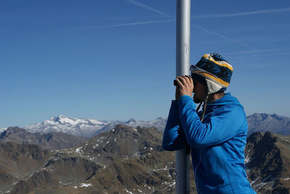 Mit Hilfe des Ferngalses werden die unzähligen Berge bestimmt. Im Hintergrund leuchtet die weiße Hochalm