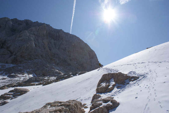 Am Weg über das Hochplateau gilt es einzelne Schneefelder zu queren, links der Gipfel