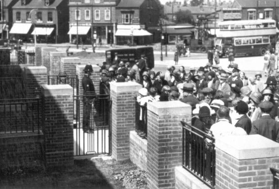 A policeman holds the crowds back