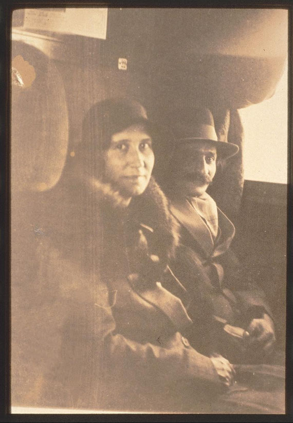 Meher Baba with Enid Corfe on a train in England - April 1932