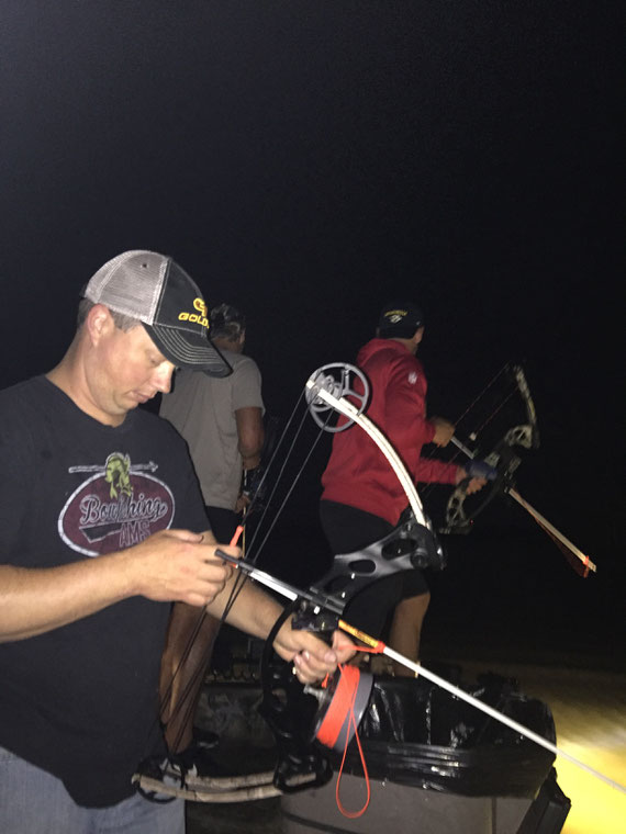 Brett Nelson in foreground with Dustin Colquitt and James Winchester in front of boat having some fun chasing carp and gar!