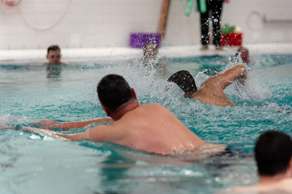 Jugendliche und Erwachsene der Schwimmgruppe Belugas beim BSV Achim trainieren aktiv ihre Schwimmtechnik und Ausdauer im Wasser.