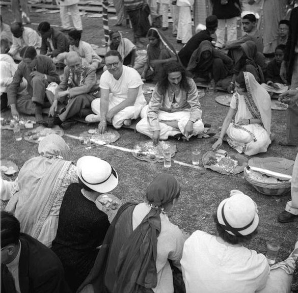 MSI Collection ; 1937 - Nasik, India - Tom is on the far left at Baba's brother - Beheram's wedding feast. Meher Baba is seated next to the groom's wife - Purin. Seated next to Baba is Garrett Fort & William Backett.