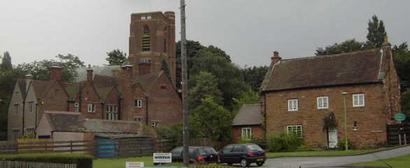 The Old Stone House (right) and St Peter's Church. The building in front of the church is the vicarage.