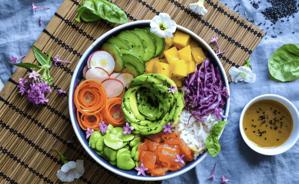 A luxury poke bowl with fresh salmon, avocado, and vegetables, designed for optimal health and fitness by a Monaco-based personal trainer
