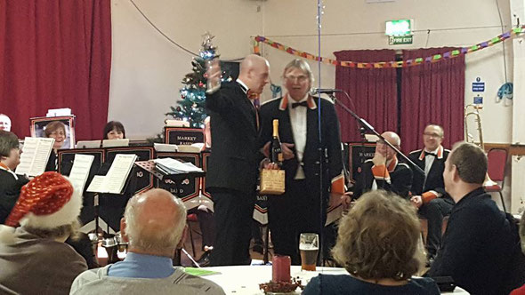 Michael Tindall (Tinny) receiving from MD David Dernley his award for 50years  with the same band