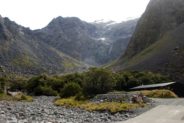 McPhersons Falls and Homer Hut  from the bed of the Hollyford River with soouth-eastern spur of Mt McPherson (1,931m) and the Homer Saddle on the left from the Milford Road.