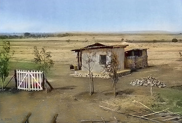 The Tin Cabin, behind which can be seen the tatta-matting around the crypt-room, in 1935 - Note the construction debris left in a pile because of Baba's seclusion- Photo taken by Padri. Image colourized by Anthony Zois.