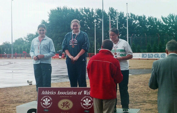 Tanya Bilous (centre) receiving her U17 Womens Hammer gold medal