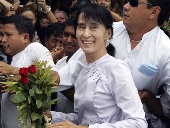 KHIN MAUNG WIN/AP Myanmar pro-democracy leader Aung San Suu Kyi, center, arrives at the headquarters of her National League for Democracy party Monday, April 2, 2012, in Yangon, Myanmar. Suu Kyi said she hopes her victory in a landmark election will mark