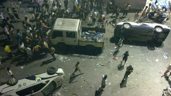 A photo dated June 12 shows damaged police cars overturned by protesters in Xintang, China