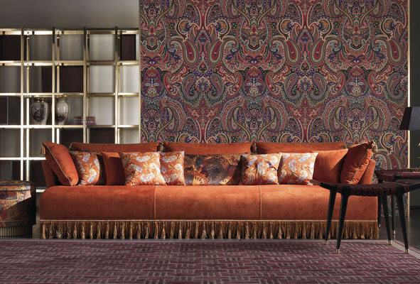 Mauritania sofa designed by Luca Tornaghi for Etro Home, compact and embracing upholstered sofa enriched by fringes and layered textiles expressing a nomadic decorative language