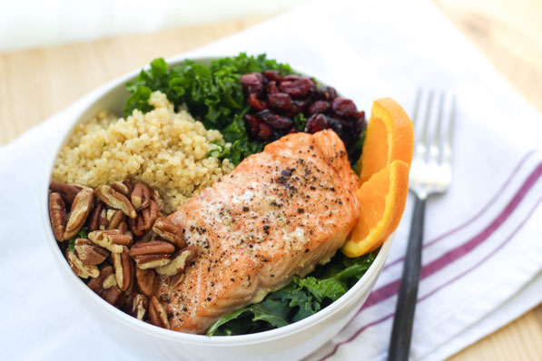 This colorful protein bowl recipe made with kale, salmon, quinoa, pecans, and cranberries is a protein-packed, fiber-filled healthy lunch that will keep you full and fueled all afternoon!