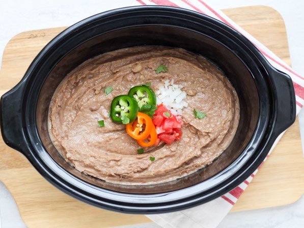 Creamy, flavorful refried beans are so easy to make in the slow cooker! These refried beans are a healthier, vegan version of classic refried beans that the whole family will love!