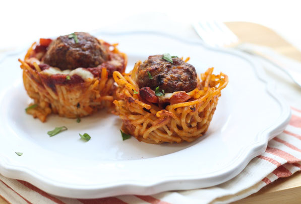 This fun version of spaghetti and meatballs is baked in a muffin tin to make "nests." It's a beautiful, perfectly portioned dinner the whole family will love! 