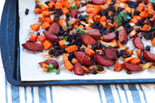 Sausage, sweet potato, onions, and black beans roast together  beautifully on a baking sheet to create the base of these delicious  (and gluten free) one-pan tacos for two!  