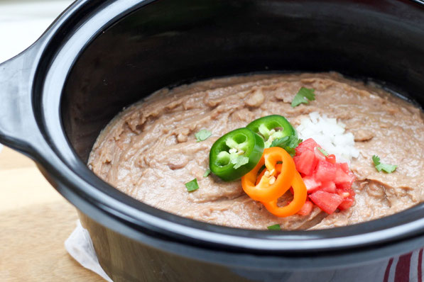 Creamy, flavorful refried beans are so easy to make in the slow cooker! These refried beans are a healthier, vegan version of classic refried beans that the whole family will love!