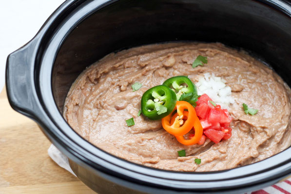 Creamy, flavorful refried beans are so easy to make in the slow cooker! These refried beans are a healthier, vegan version of classic refried beans that the whole family will love!