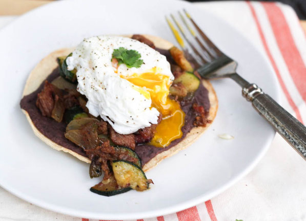 These tasty tostadas with beef, zucchini, black beans, and a poached egg are a tasty way to turn last night's beef dinner into a delicious high protein breakfast!