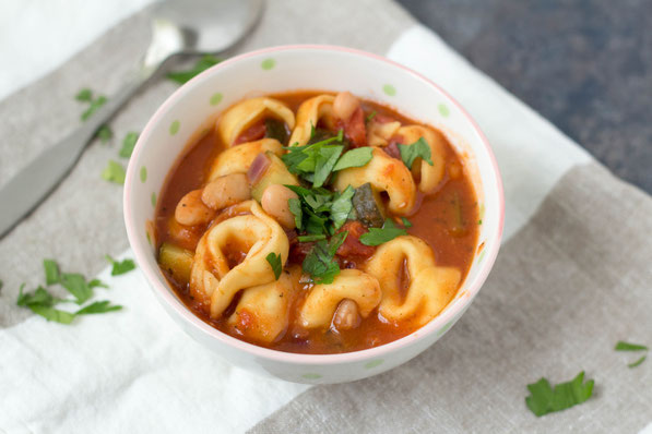 This simple 20-minute soup is perfect for a busy day! Cheese tortellini, white beans, zucchini, and Italian spices make for one tasty and family-friendly vegetarian dinner!