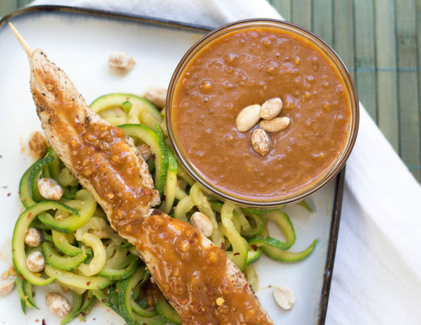 Zucchini noodles coated in a delicious peanut-sauce served with chicken skewers is a light and flavorful weeknight meal the whole family will love!