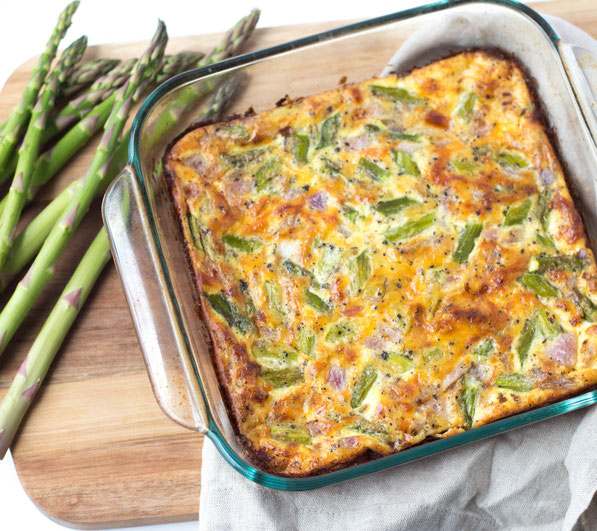 Fresh asparagus makes the perfect veggie base for this cheesy ham and egg casserole! 