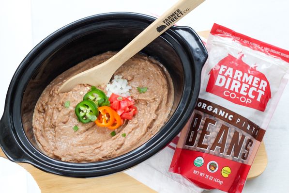 Creamy, flavorful refried beans are so easy to make in the slow cooker! These refried beans are a healthier, vegan version of classic refried beans that the whole family will love!