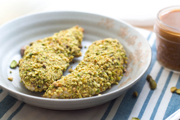 These healthy pistachio-crusted chicken tenders come together in just a few minutes, and the homemade BBQ honey-mustard dipping sauce is the perfect fun addition to this tasty dinner!