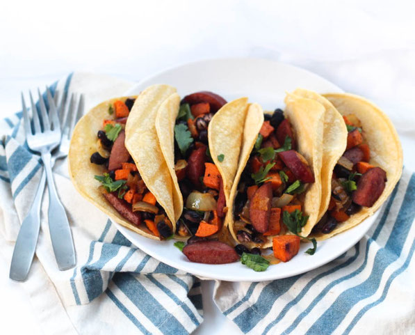 Sausage, sweet potato, onions, and black beans roast together  beautifully on a baking sheet to create the base of these delicious  (and gluten free) one-pan tacos for two!  