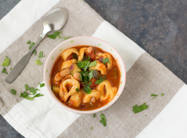 This simple 20-minute soup is perfect for a busy day! Cheese tortellini, white beans, zucchini, and Italian spices make for one tasty and family-friendly vegetarian dinner!