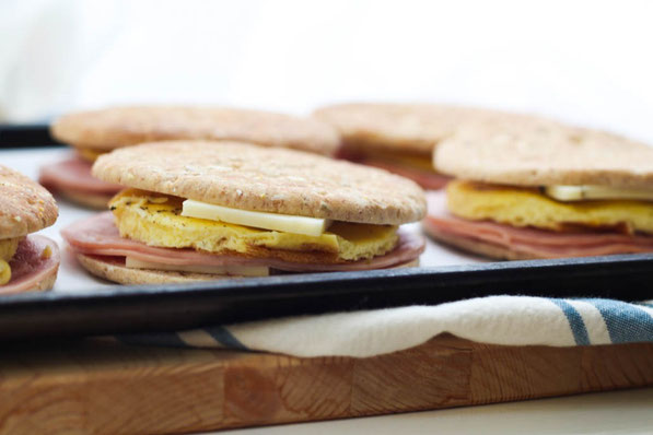 Freezer-friendly egg sandwiches with ham, pepper jack cheese, and whole grain sandwich thins are the ultimate healthy "fast food" breakfast recipe!  It's a fun breakfast the whole family will love for weekdays!