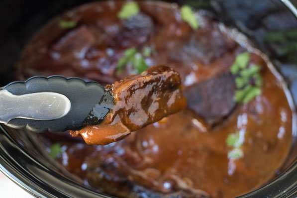 This easy recipe for slow cooker BBQ beef ribs is one of the most requested recipes by family and friends when we have company over.  And the best part is, it takes only  a few minutes to prep, and the result is this beautiful dish everyone will love!