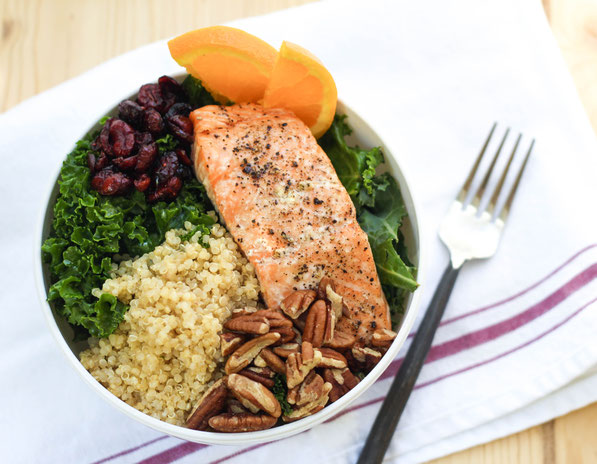 This colorful protein bowl recipe made with kale, salmon, quinoa, pecans, and cranberries is a protein-packed, fiber-filled healthy lunch that will keep you full and fueled all afternoon! 