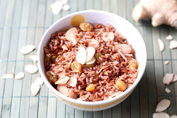 Fresh ginger, almonds, and golden raisins make this easy pink rice pilaf extra special!